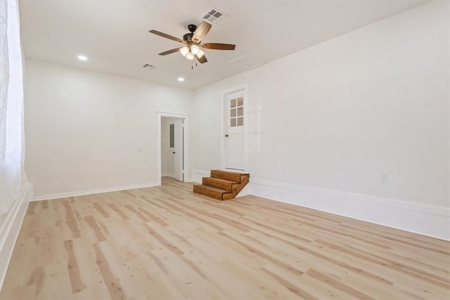 spare room featuring light hardwood / wood-style floors and ceiling fan