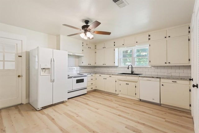 kitchen featuring white appliances, sink, extractor fan, and light hardwood / wood-style flooring