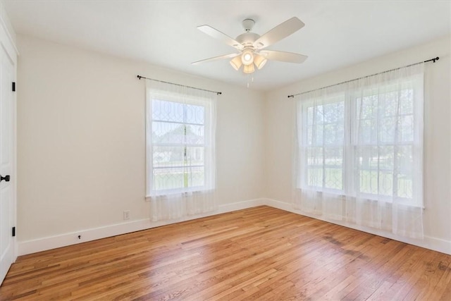 empty room featuring light wood-type flooring and ceiling fan