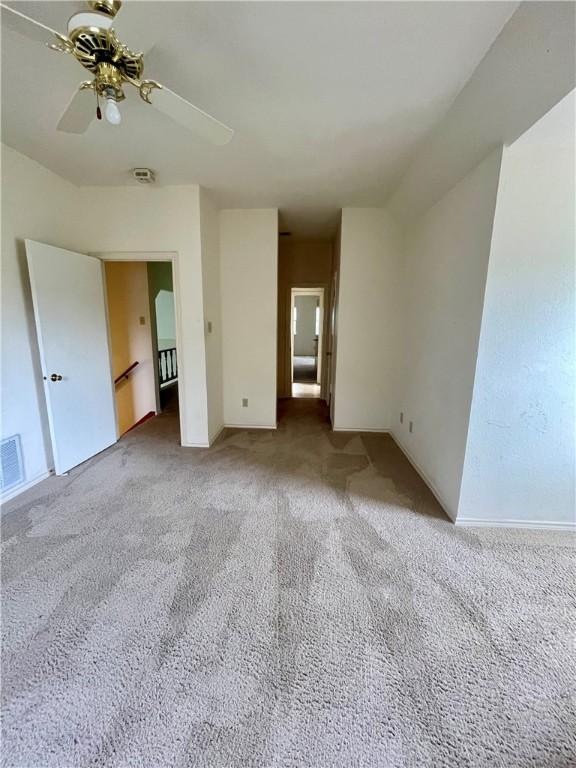 empty room with carpet flooring and ceiling fan