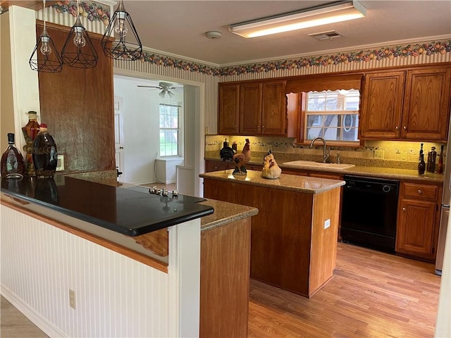 kitchen featuring kitchen peninsula, black dishwasher, a wealth of natural light, and sink