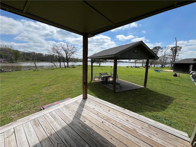 wooden terrace with a gazebo, a water view, and a yard