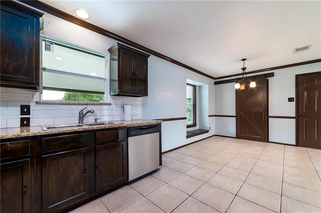 kitchen featuring crown molding, sink, pendant lighting, a barn door, and dishwasher