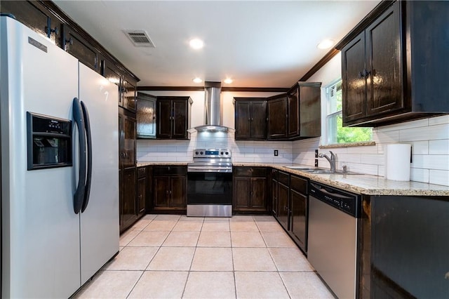 kitchen with tasteful backsplash, ornamental molding, stainless steel appliances, sink, and wall chimney range hood