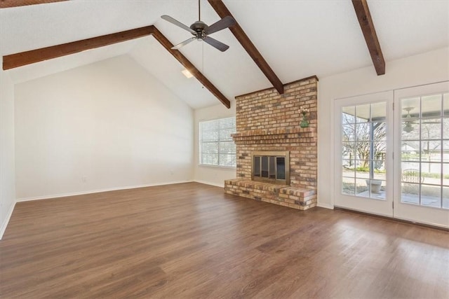 unfurnished living room with beam ceiling, a fireplace, a ceiling fan, wood finished floors, and baseboards