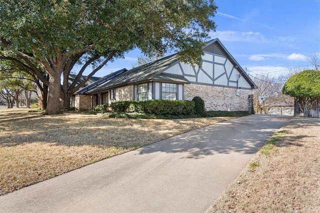 tudor-style house with brick siding