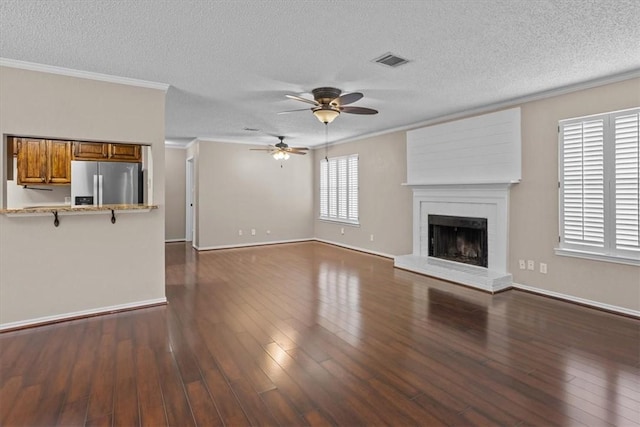 unfurnished living room with ornamental molding, dark wood-type flooring, and ceiling fan