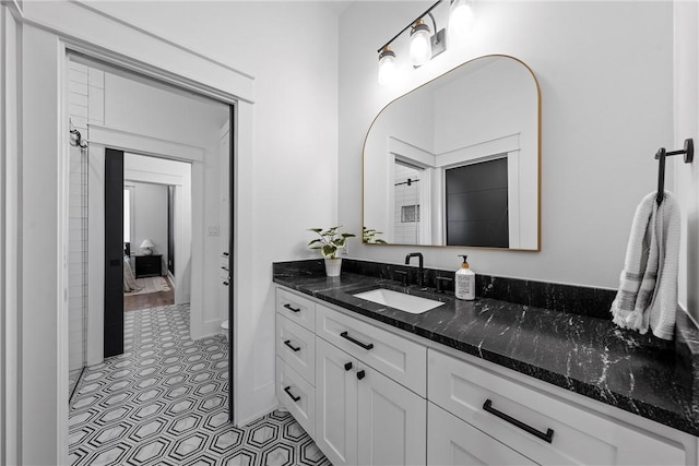 bathroom featuring tile patterned flooring and vanity