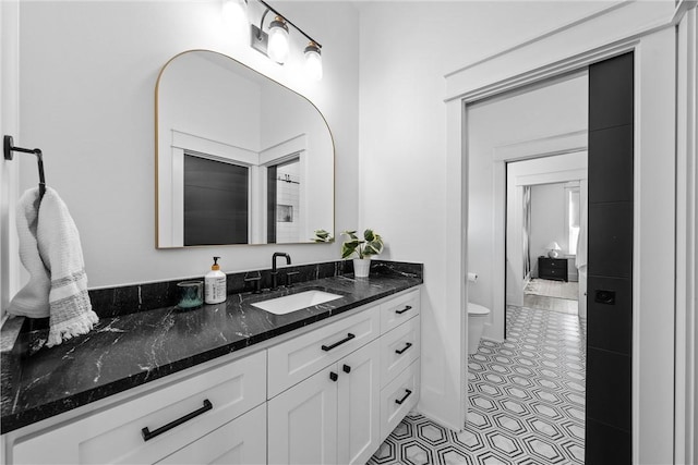 bathroom featuring tile patterned floors, toilet, and vanity