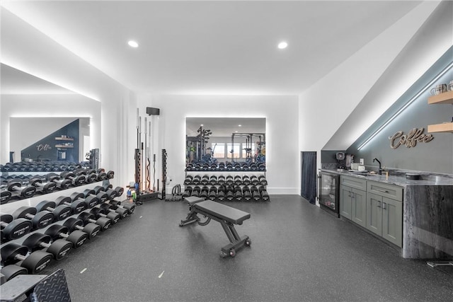 workout area featuring beverage cooler and indoor wet bar