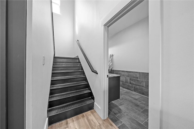 stairs featuring hardwood / wood-style floors