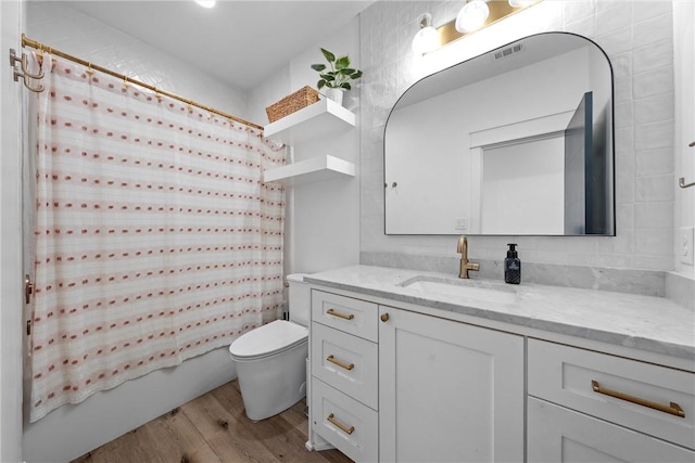 full bathroom with vanity, hardwood / wood-style flooring, toilet, and shower / bath combo with shower curtain