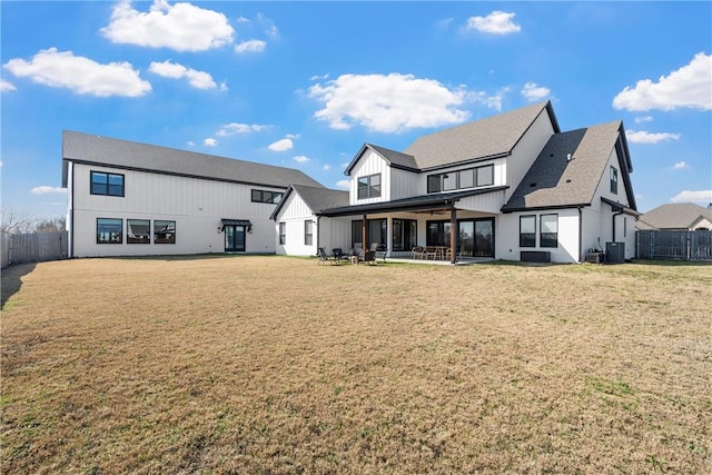 back of house featuring a yard, a patio area, and central air condition unit