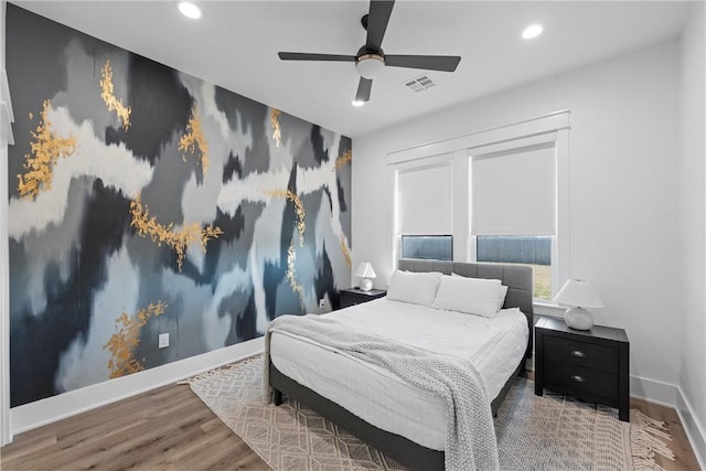 bedroom featuring hardwood / wood-style flooring and ceiling fan