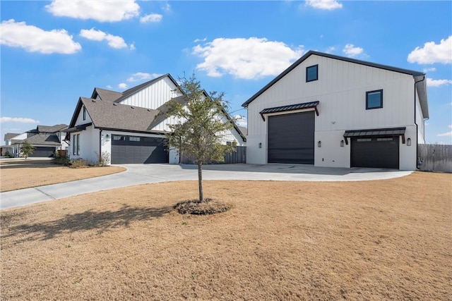 modern inspired farmhouse with a garage and a front yard