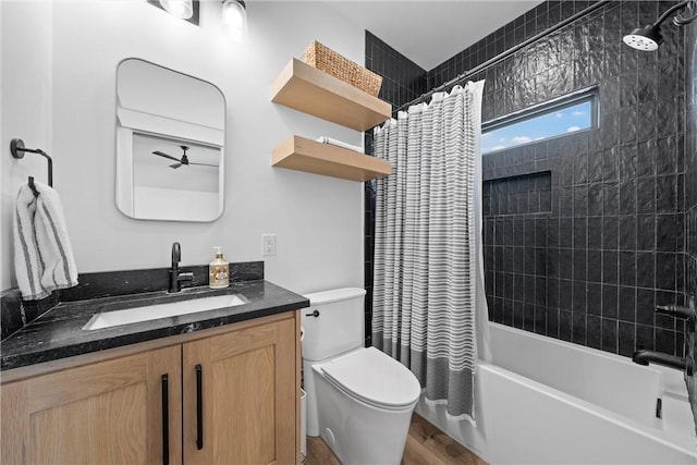 full bathroom with hardwood / wood-style flooring, vanity, shower / tub combo with curtain, and toilet