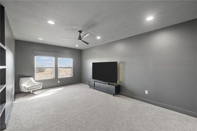 unfurnished room with light colored carpet and ceiling fan