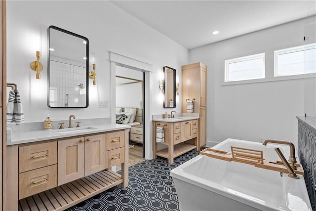 bathroom featuring vanity and a bath