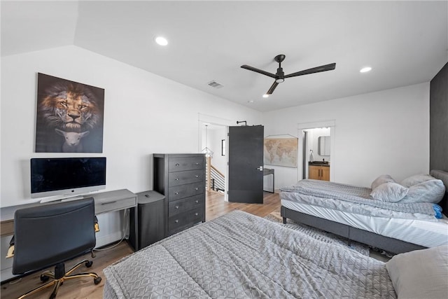 bedroom featuring vaulted ceiling, ensuite bathroom, ceiling fan, and light hardwood / wood-style flooring