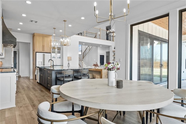 dining space featuring a chandelier and light hardwood / wood-style floors