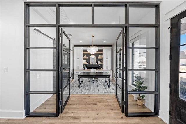 interior space featuring an inviting chandelier and hardwood / wood-style floors