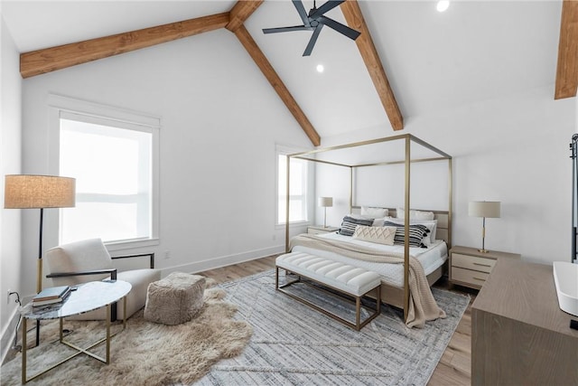 bedroom with high vaulted ceiling, beam ceiling, light hardwood / wood-style floors, and ceiling fan