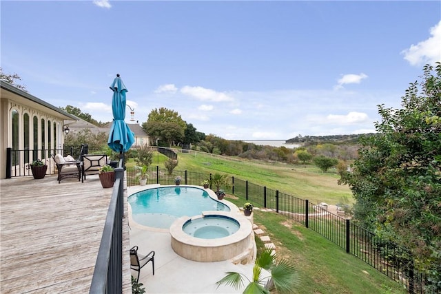 view of swimming pool with an in ground hot tub, a yard, and a deck