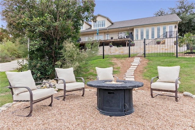 rear view of house featuring a fire pit and a yard