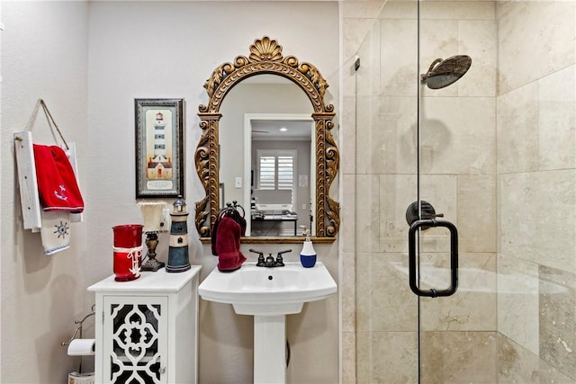 bathroom with an enclosed shower and sink