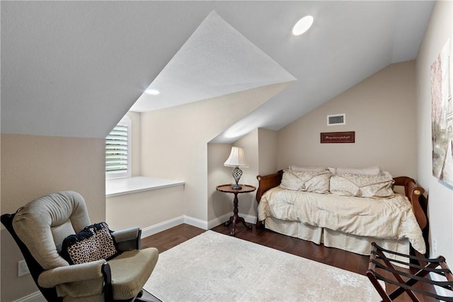 bedroom featuring dark hardwood / wood-style floors and vaulted ceiling