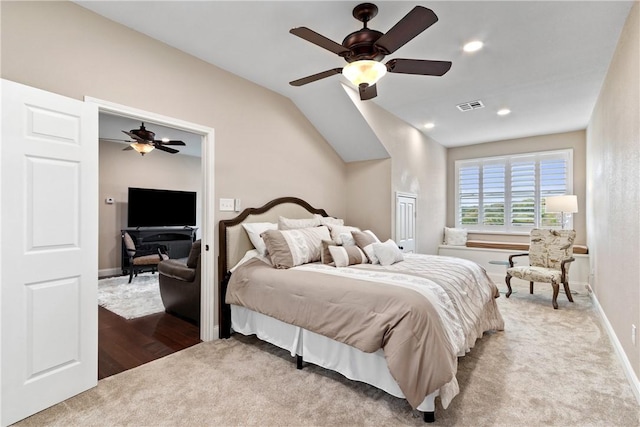 bedroom featuring ceiling fan, light wood-type flooring, and vaulted ceiling