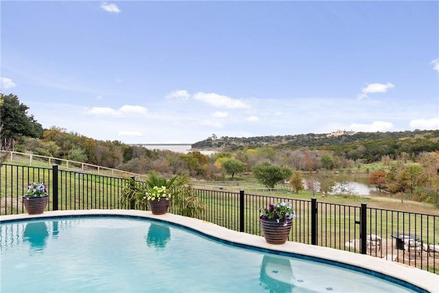 view of pool featuring a water view