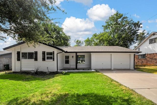 single story home featuring a garage and a front lawn