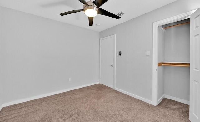 unfurnished bedroom with ceiling fan, a closet, and light colored carpet