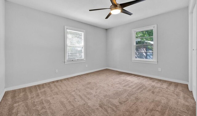 spare room featuring carpet flooring and ceiling fan