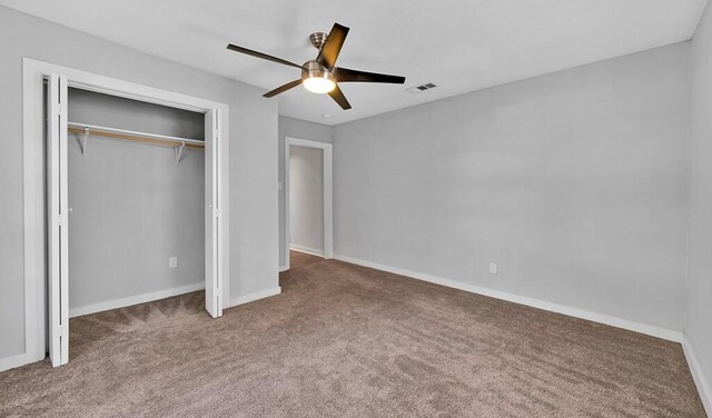 unfurnished bedroom featuring carpet flooring, ceiling fan, and a closet