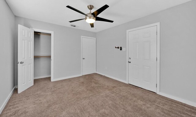 unfurnished bedroom featuring ceiling fan and light colored carpet