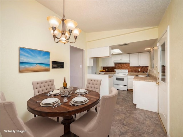 dining area with visible vents, a textured ceiling, lofted ceiling, and an inviting chandelier