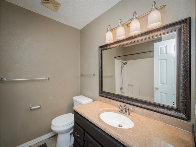 bathroom with visible vents, toilet, a textured ceiling, baseboards, and vanity