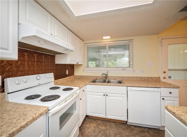 kitchen featuring under cabinet range hood, white cabinets, white appliances, and a sink