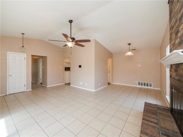 unfurnished living room with visible vents, a ceiling fan, light tile patterned floors, lofted ceiling, and a brick fireplace