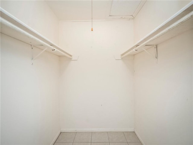 spacious closet with light tile patterned floors