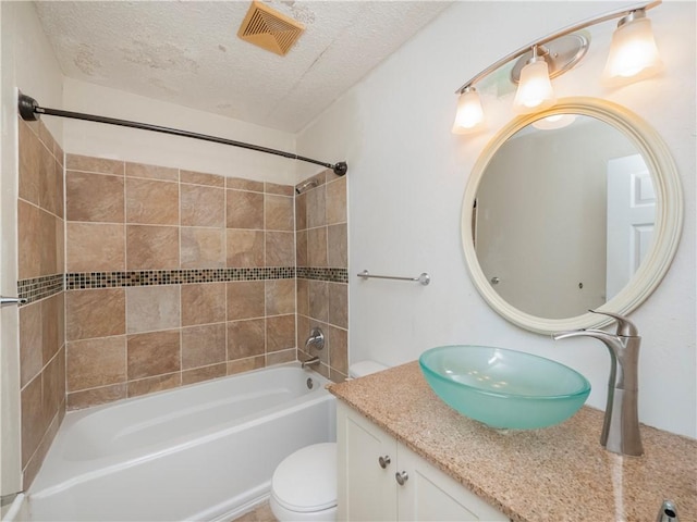 full bath with vanity, a textured ceiling, visible vents, shower / bath combination, and toilet