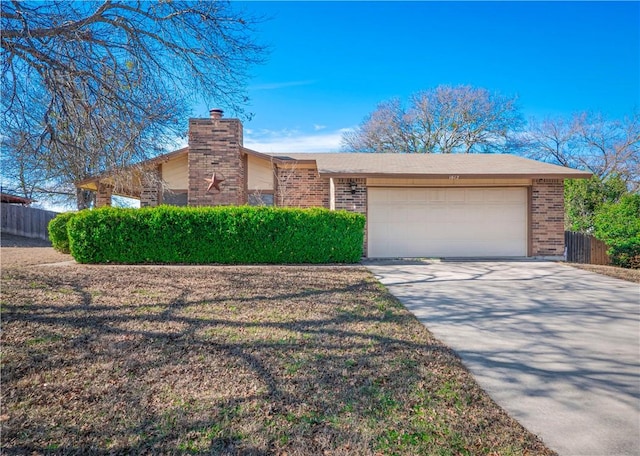 view of front facade with brick siding, concrete driveway, an attached garage, and fence