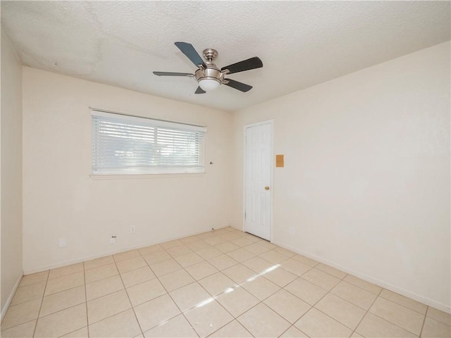 unfurnished room featuring light tile patterned floors, a textured ceiling, and ceiling fan