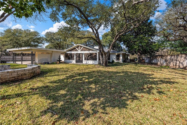 view of yard with a sunroom and a carport