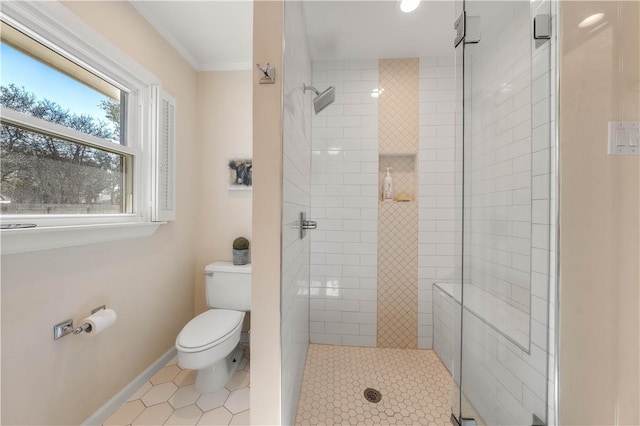 bathroom featuring ornamental molding, a shower with shower door, and toilet