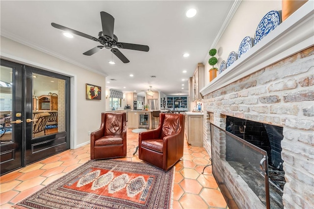 tiled living room featuring french doors, ornamental molding, and a stone fireplace