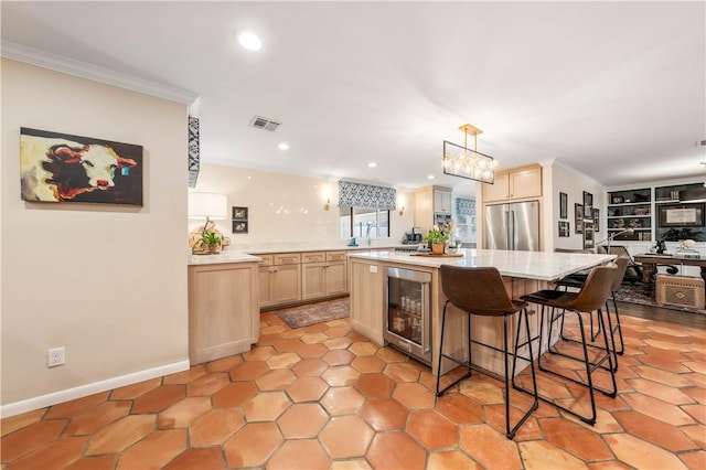 kitchen with wine cooler, ornamental molding, kitchen peninsula, high end fridge, and light brown cabinets