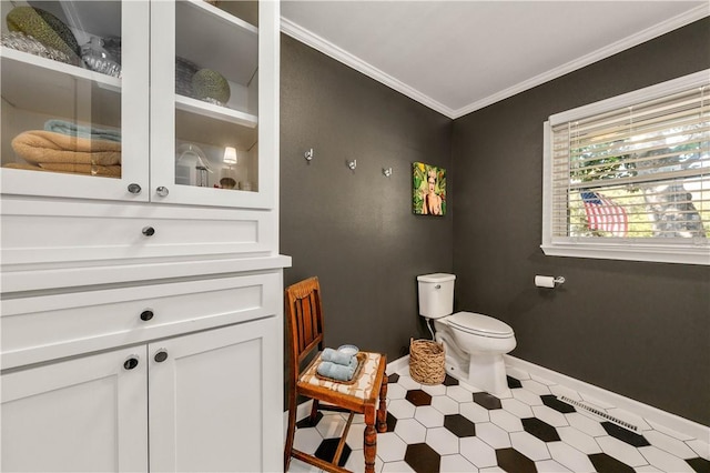 bathroom featuring ornamental molding and toilet